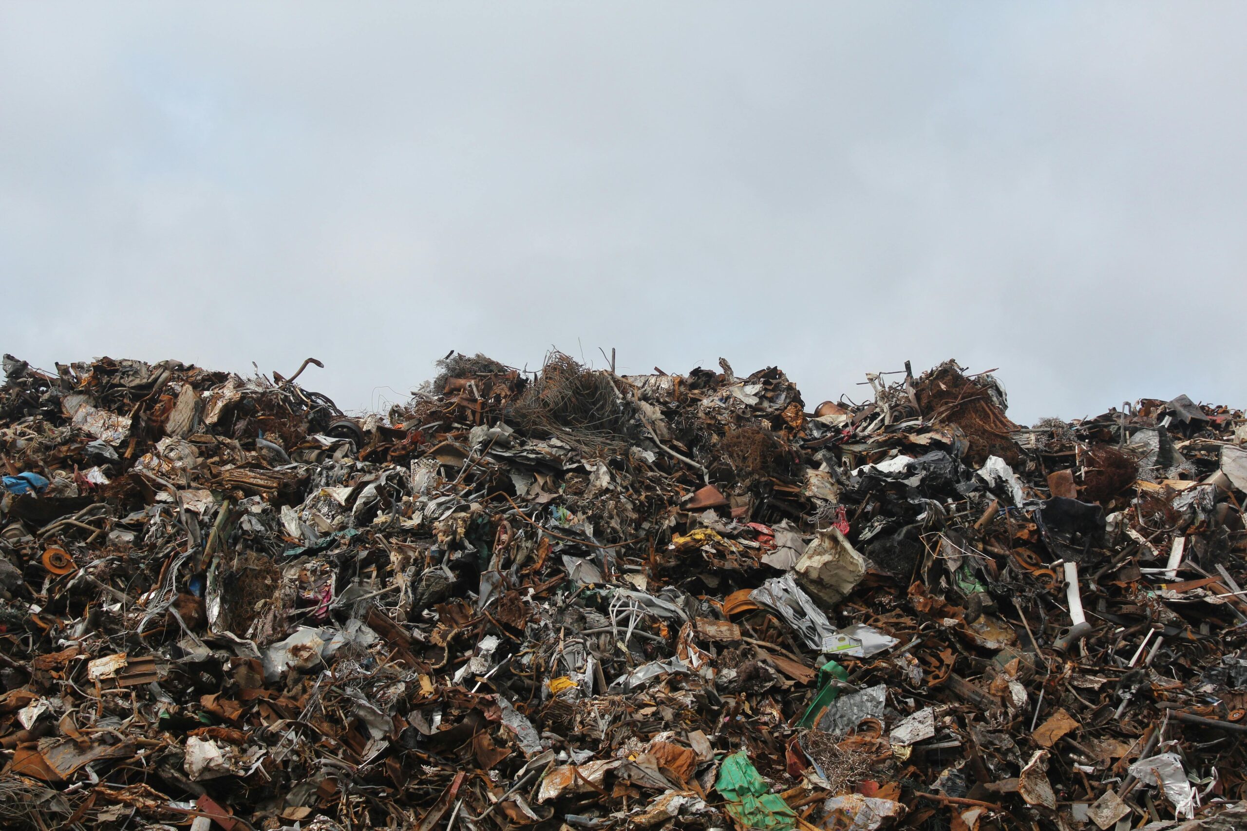 A pile of discarded smart furniture pieces at a landfill site