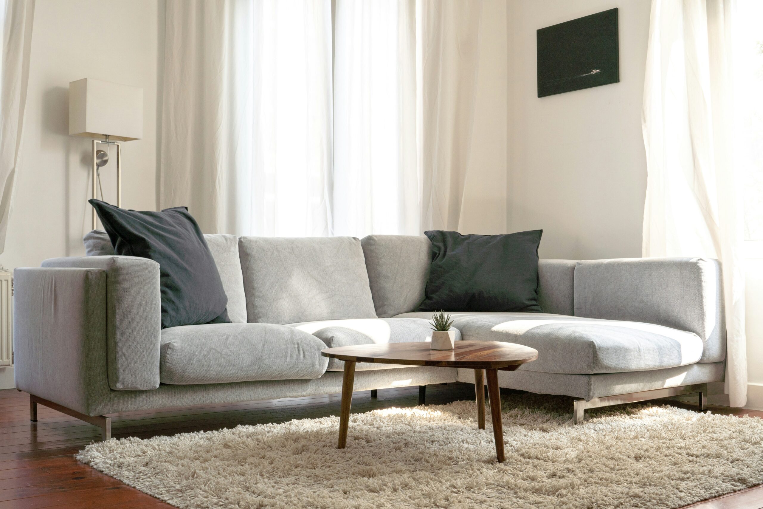 A sleek living room featuring a smart sofa with built-in charging ports and ambient lighting