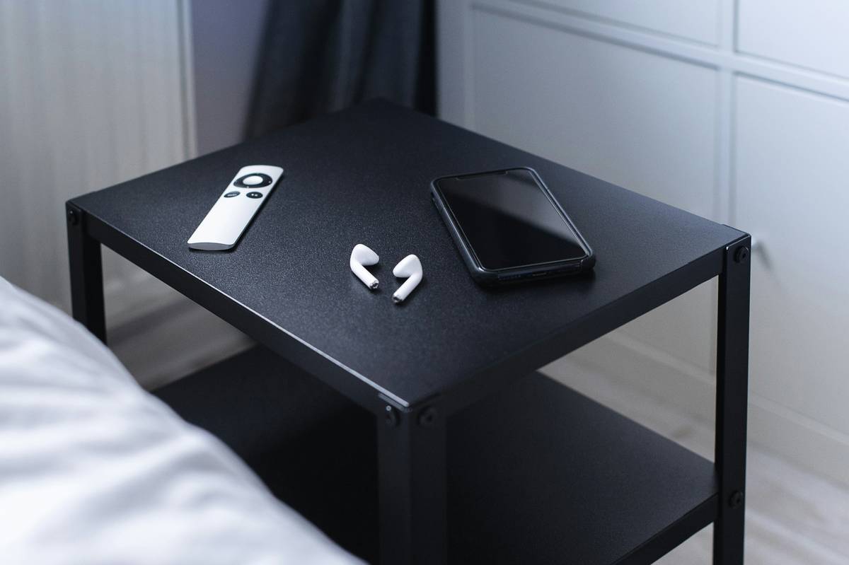 A person interacting with a smartphone app connected to smart furniture
