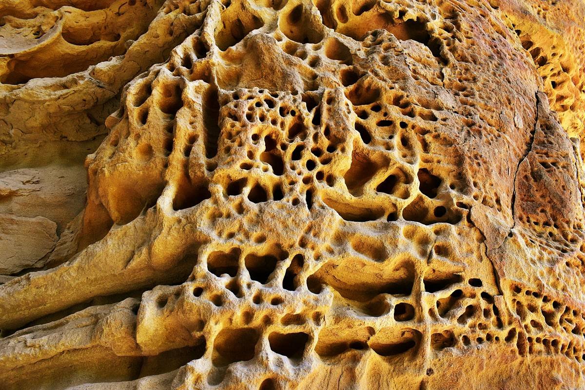 A minimalist desk crafted from recycled plastic bottles featuring wireless charging areas.