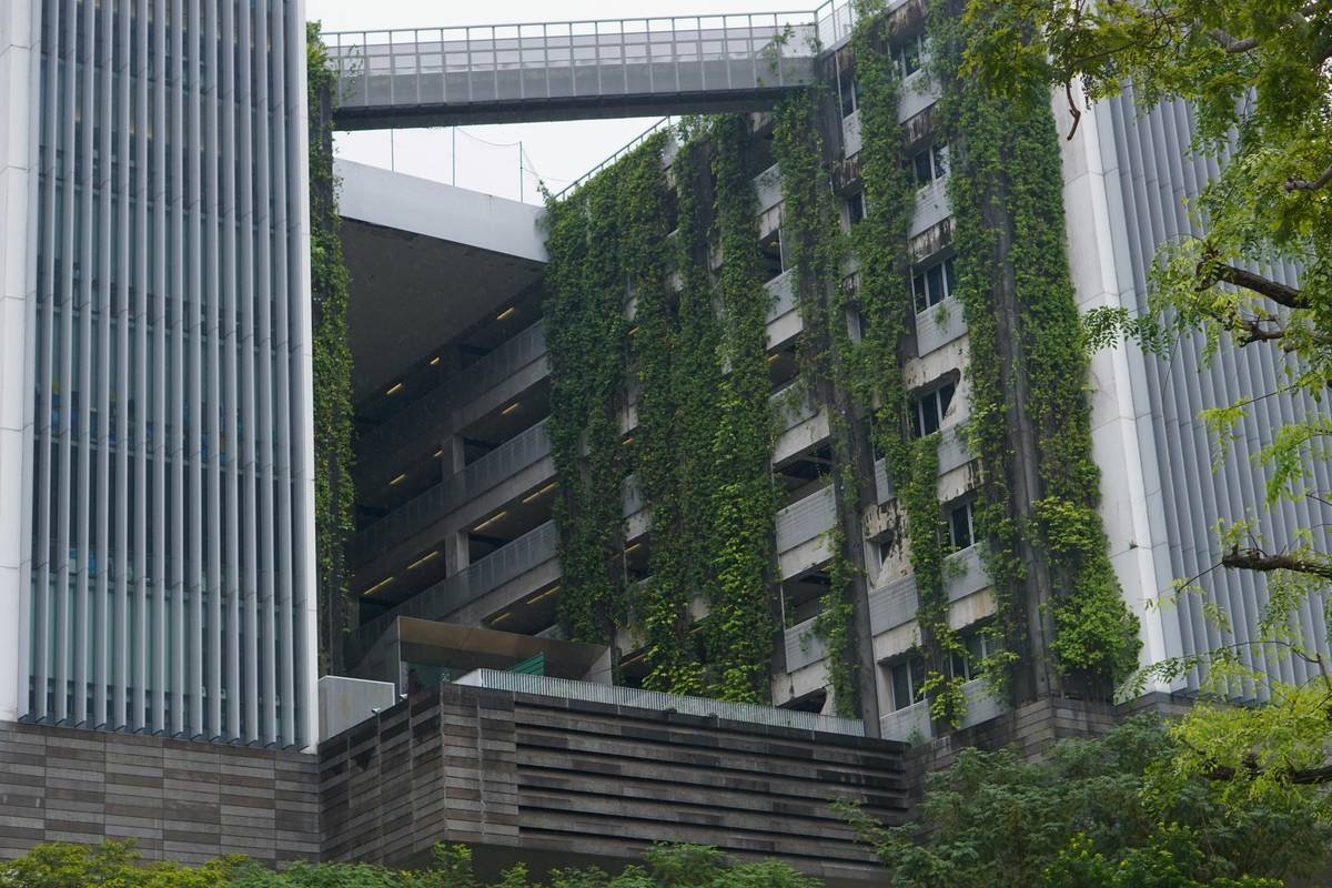 Photo of a modern living room showcasing eco-certified smart furniture, such as a motorized desk and a motion-sensing couch.